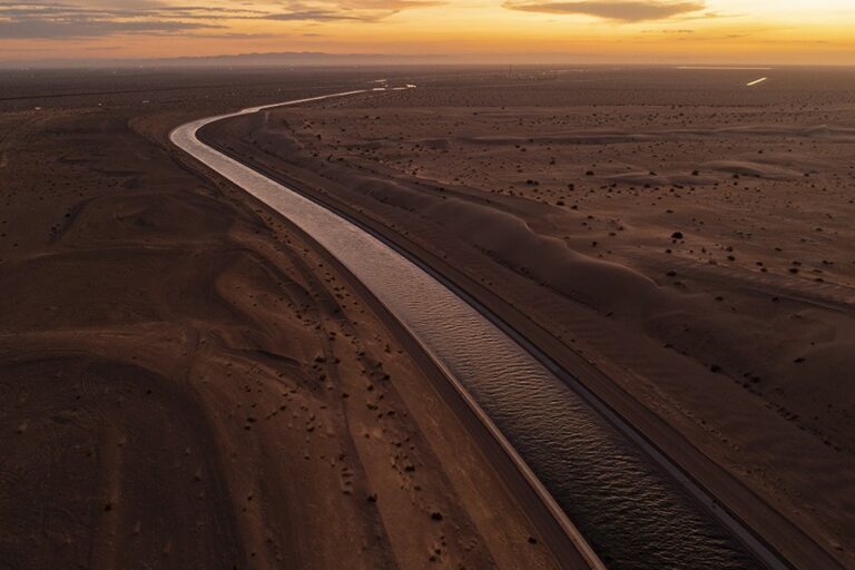 FELICITY, CALIFORNIA - SEPTEMBER 28: In an aerial view, the All-American Canal conveys water through the Imperial Sand Dunes of California's Colorado Desert, a few miles north of the U.S.-Mexico border, on September 28, 2022 near Felicity, California. The 80-mile long canal carries water from the Colorado River to supply nine Southern California cities and 500,000 acres of farmland in the Imperial Valley where a few hundred farms draw more water from the Colorado River than the states of Arizona and Nevada combined. As drought shrinks the Colorado River to historic low levels and with states that rely on it facing major water shortages, pressure is building on the growers to give up some of the water rights they had inherited long ago. The Imperial Sand Dunes are the remnants of the beach sands of ancient Lake Cahuilla, the basin of which is where the dying Salton Sea is located. The federal government has proposed an unprecedented plan to cut back on water supplies for Arizona, Nevada and California, where millions of people rely on its water and power, as climate change-driven drought continues to lower water levels at the biggest reservoirs in the nation, lakes Mead and Powell, to historic low capacities.  (Photo by David McNew/Getty Images)