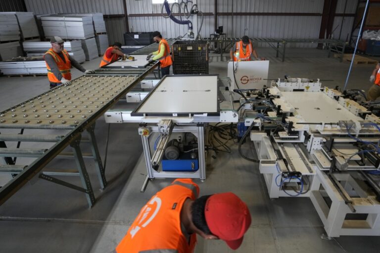 Workers take apart solar panels as they begin the recycling process at We Recycle Solar on Tuesday, June 6, 2023, in Yuma, Ariz. North America