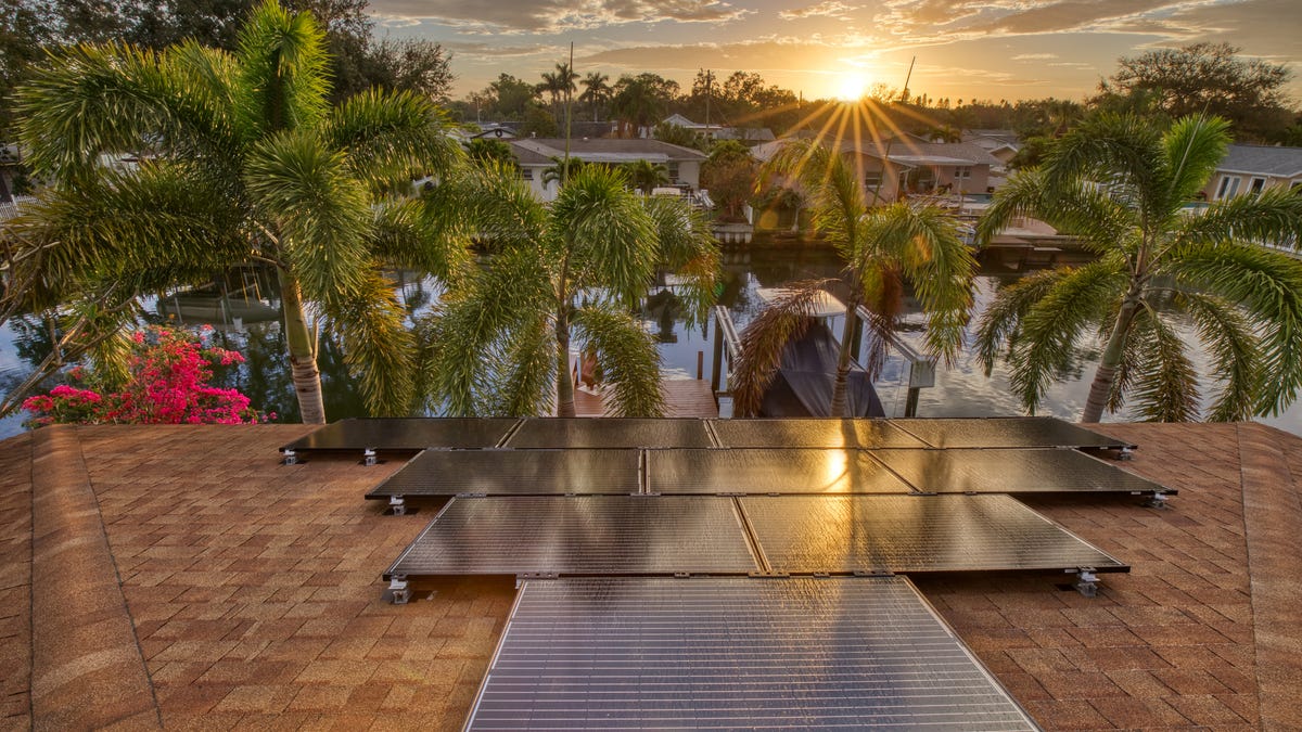 Solar panels on a residential house in Florida with the sun just starting to rise.